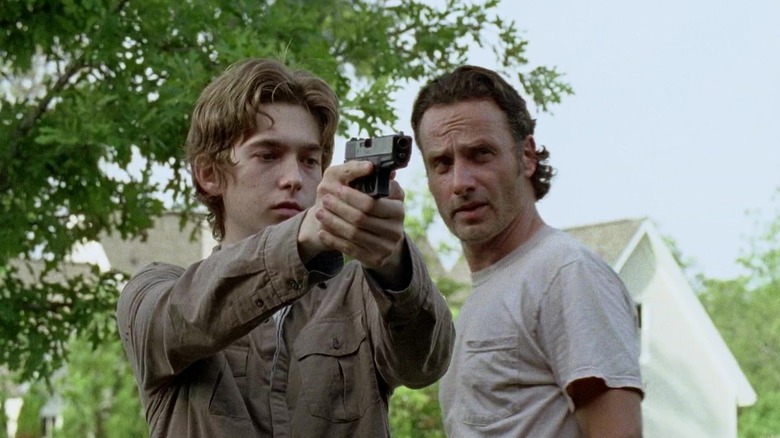 Rick teaches Ron how to shoot in "The Walking Dead" (2010)