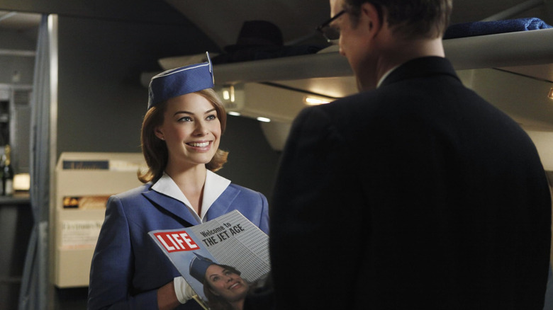 Pan Am Laura Cameron talking to Roger Anderson on plane