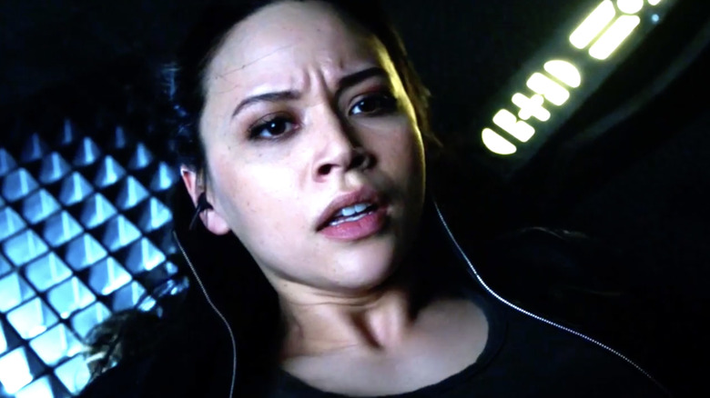 Melissa O'Neil as Two looking distressed on the floor of a spaceship on "Dark Matter."