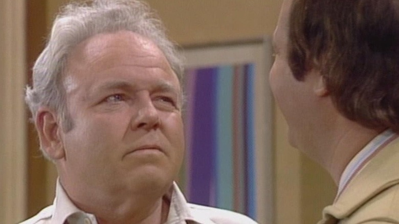 Archie Bunker (Carroll O'Connor) glares suspiciously in All in the Family