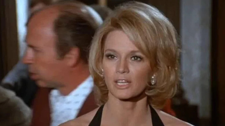 Pepper Anderson (Angie Dickinson) stands in a cocktail dress in Police Woman