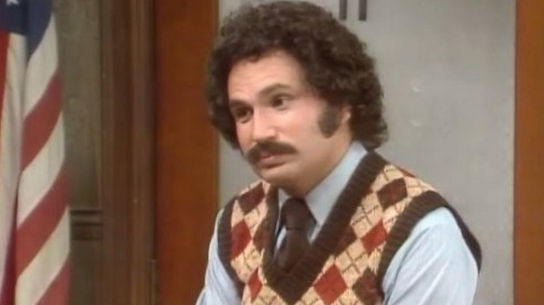 Gabe Kotter (Gabe Kaplan) sits with a nonplussed expression in Welcome Back, Kotter
