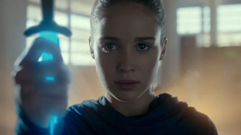 Alba Baptista as Ava holding glowing blue sword in "Warrior Nun."
