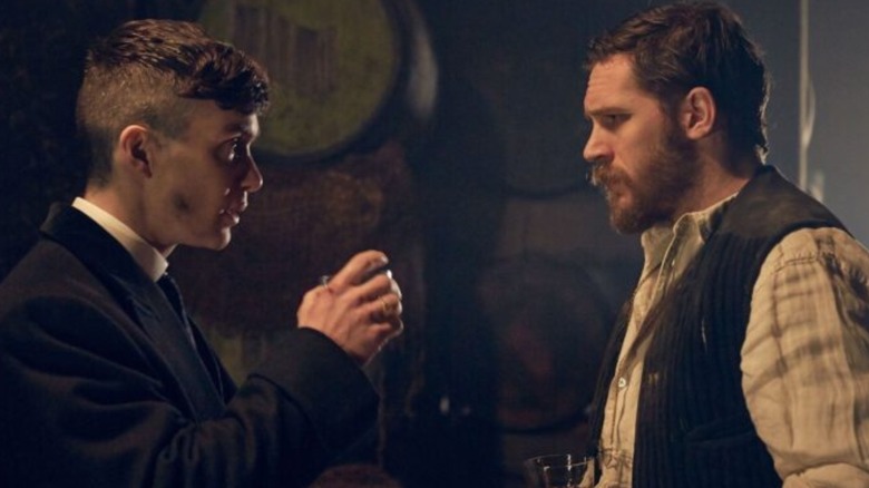 Tommy Shelby drinking whisky in front of Alfie Solomons in Peaky Blinders