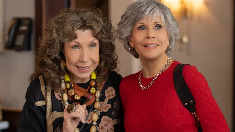 Lily Tomlin smiling as Frankie next to Jane Fonda as Grace in Grace and Frankie