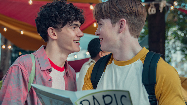 Joe Locke as Charlie smiling at Kit Connor as Nick in Heartstopper