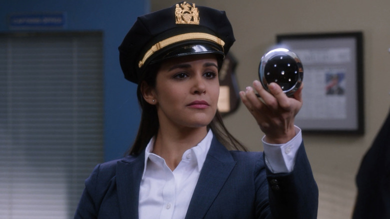 Melissa Fumero as Amy Santiago trying on a captain's hat in "Brooklyn Nine-Nine."