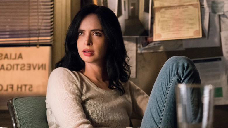 Krysten Ritter as Jessica Jones sitting in her office in "Jessica Jones."