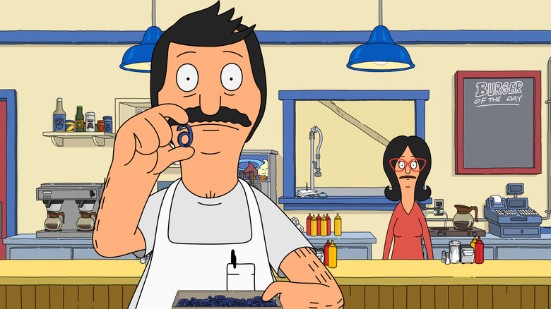 Bob (H. Jon Benjamin) puts up a letter while Linda (John Roberts) watches in Bob's Burgers