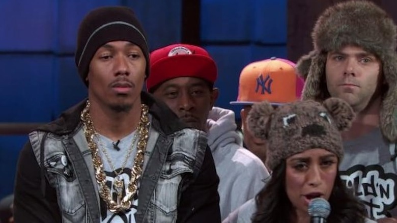 Nick Cannon standing with Rasika Mathur and Mikey Day in Wild n Out