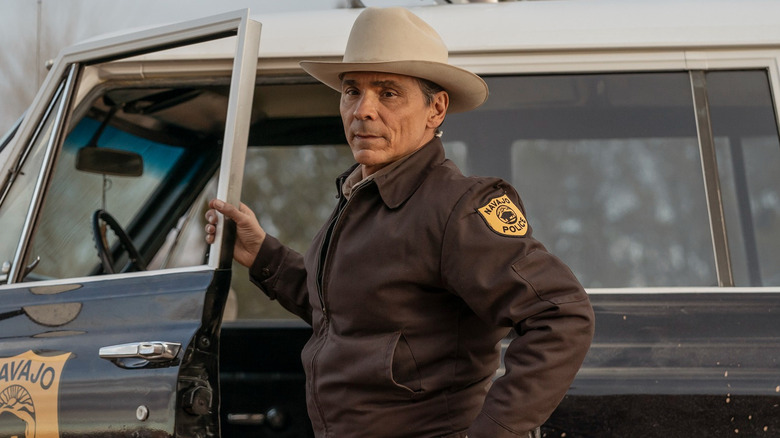 Joe Leaphorn (Zahn McClarnon) opens his car door while looking away in Dark Winds