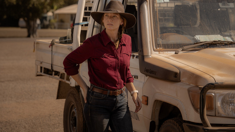 Emily Lawson (Anna Torv) stands by a pickup truck in Territory