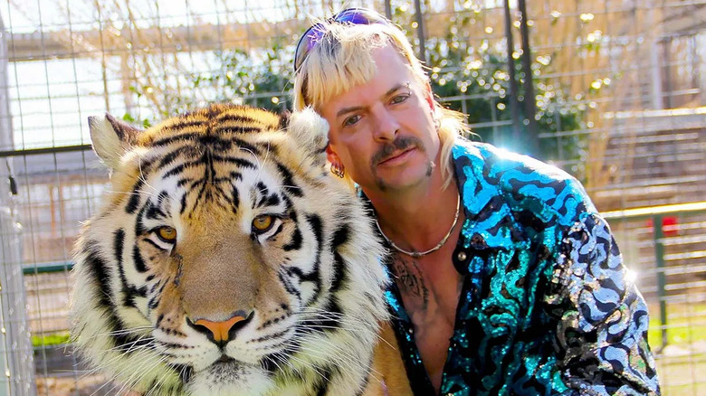 Joe Exotic poses with a tiger in Tiger King.