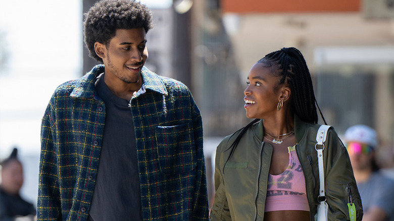 Michael Cooper Jr. as Justin walking next to Lovie Simone as Keisha in Forever