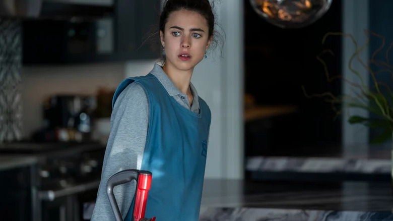 Margaret Qualley as Alex in blue maid uniform in Maid