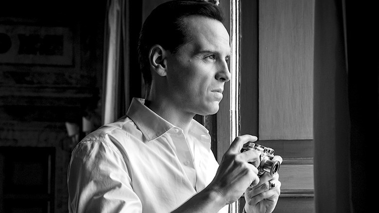 Andrew Scott as Ripley in black and white holding camera in Ripley