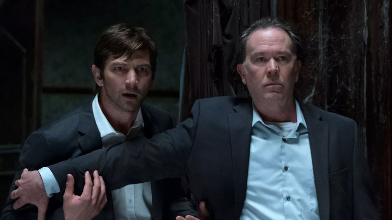 Two men look scared inside Hill House