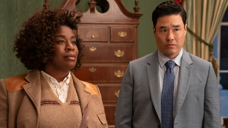 A detective and colleague stand in a room inside the White House