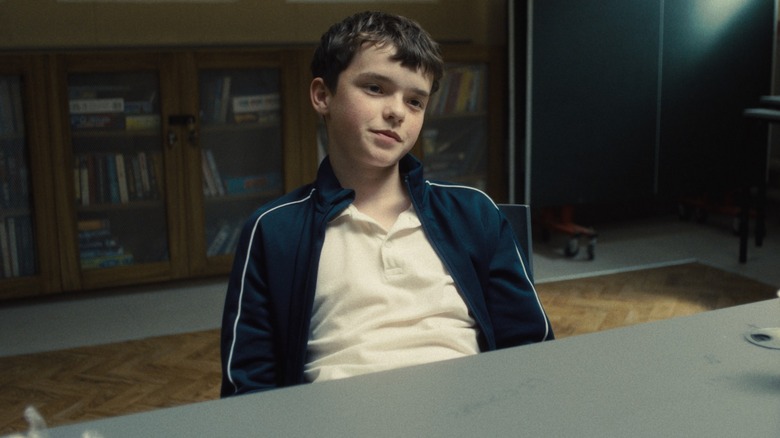 Jamie sits at a table in at the police station in "Adolescence."