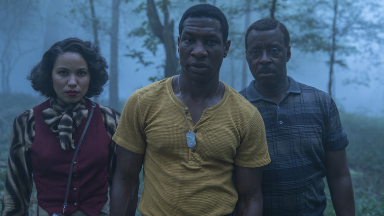 Atticus, Leti, and George walk through the woods in Lovecraft Country
