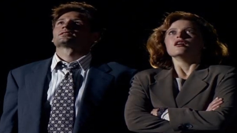 Mulder and Scully look up at the sky