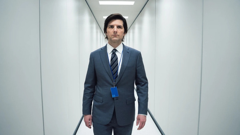 Mark Scout (Adam Scott) walks through a narrow, sterile hallway in Severance