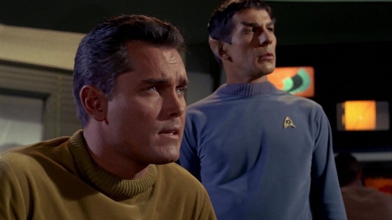 Christopher Pike (Jeffrey Hunter) and Spock (Leonard Nimoy) gaze intently at the viewscreen in Star Trek: The Original Series