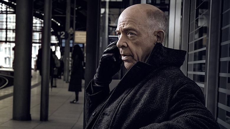 J.K. Simmons as Howard Silk talking on the phone on a train platform in Counterpart