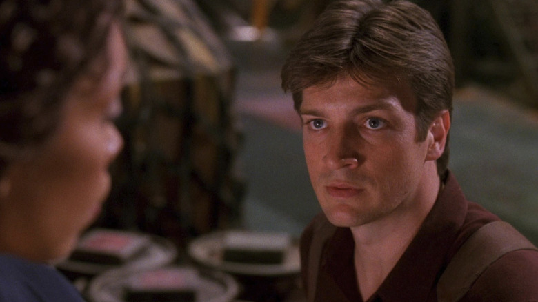 Nathan Fillion as Mal looking at Gina Torres as Zoe in Firefly