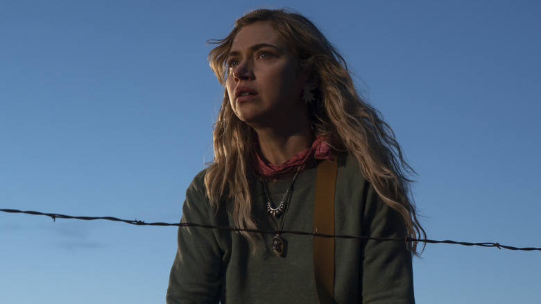 Imogen Poots as Autumn standing by a wire fence in Outer Range