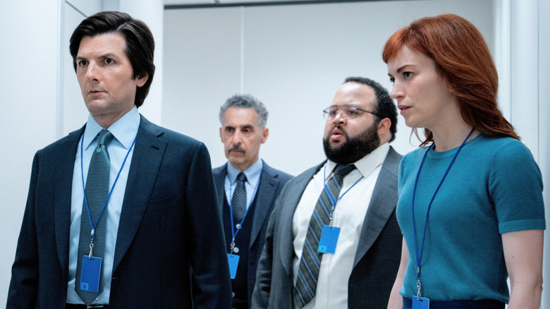 Adam Scott as Mark S., John Turturro as Irving B., Zach Cherry as Dylan G., and Britt Lower as Helena standing in a hallway in Severance