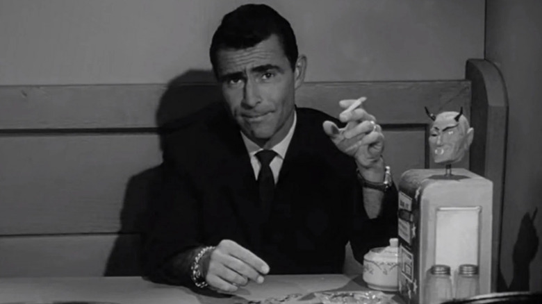Rod Serling as himself with a cigarette sitting in a diner booth in The Twilight Zone