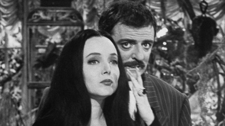 Carolyn Jones as Morticia and John Astin as Gomez share an affectionate moment on The Addams Family.