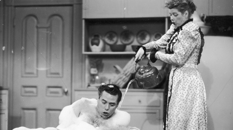 Lucille Ball as Lucy attempts to help bathe husband Ricky, played by Desi Arnaz, on I Love Lucy.