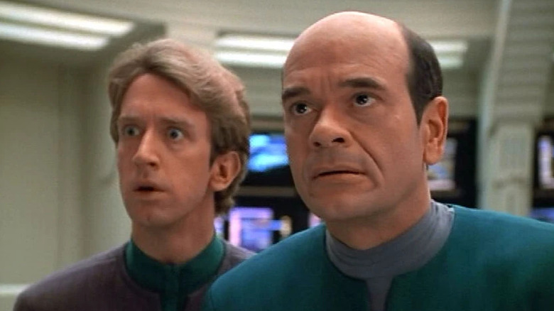 EMH Mark II (Andy Dick) and the Doctor (Robert Picardo) look up in surprise in Star Trek: Voyager