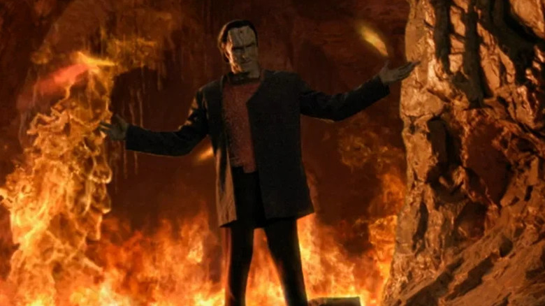 Dukat (Marc Alaimo) stands in front of a fire burning in a cave in Star Trek: Deep Space Nine