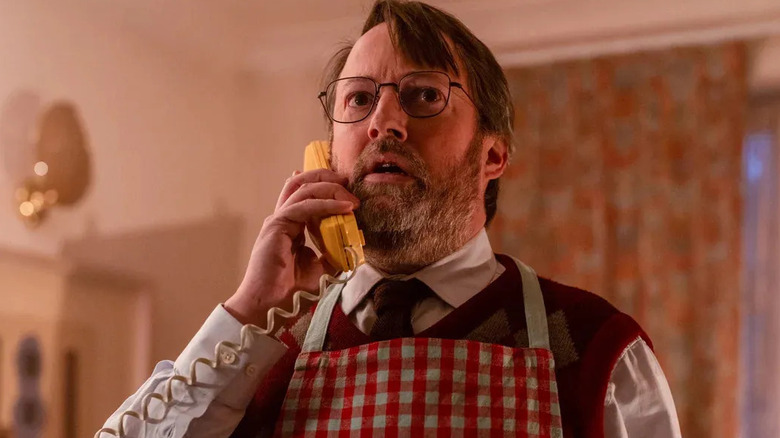 John Taylor (David Mitchell) answers the phone in Ludwig