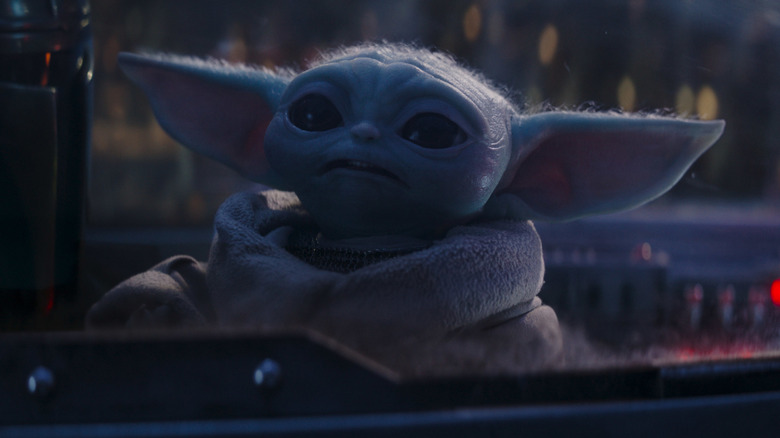 The Mandalorian (Pedro Pascal) and Grogu fly in a ship in The Mandalorian