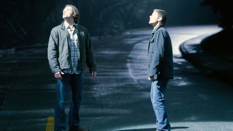 Sam Winchester (Jared Padalecki) and Dean Winchester (Jensen Ackles) stare up at a blinding white light in Supernatural