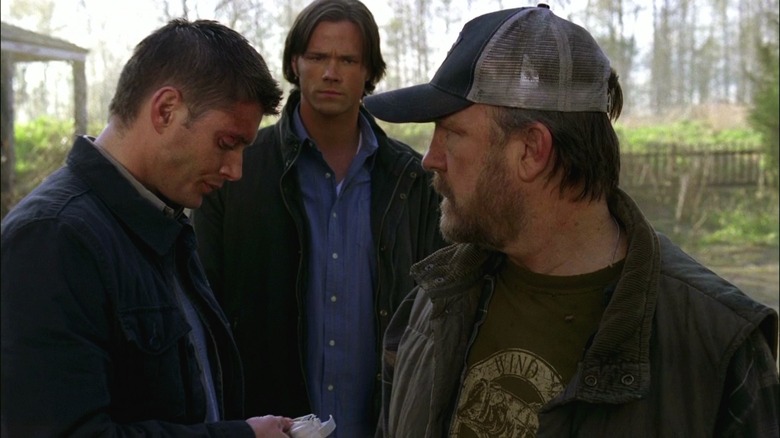 Sam Winchester (Jared Padalecki) studies Dean Winchester (Jensen Ackles) and Bobby Singer (Jim Beaver) as they talk in Supernatural