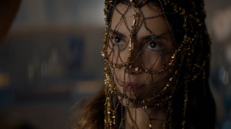 A woman in an elaborate face covering