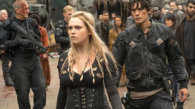 Clark Griffin and Bellamy Blake walking past soldiers in a scene from The 100