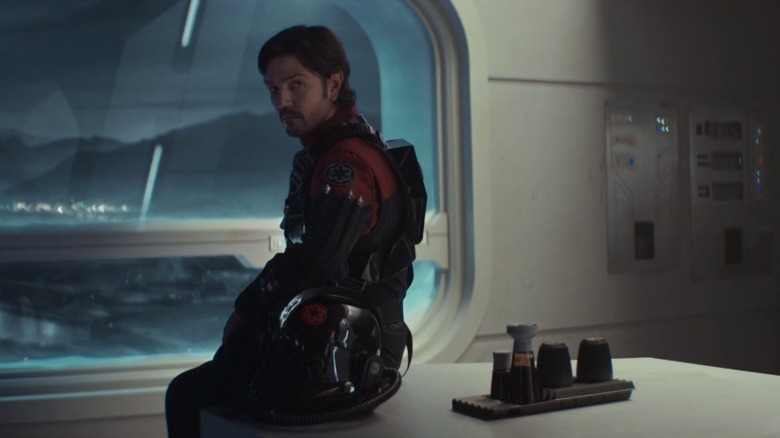 Cassian Andor standing next to a window on Andor S2E1