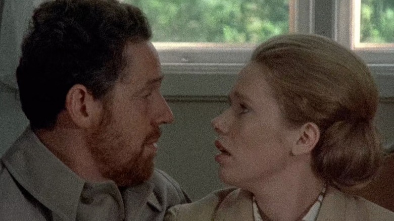 Johan and Marianne sitting together and locking eyes on Scenes from a Marriage S1E2