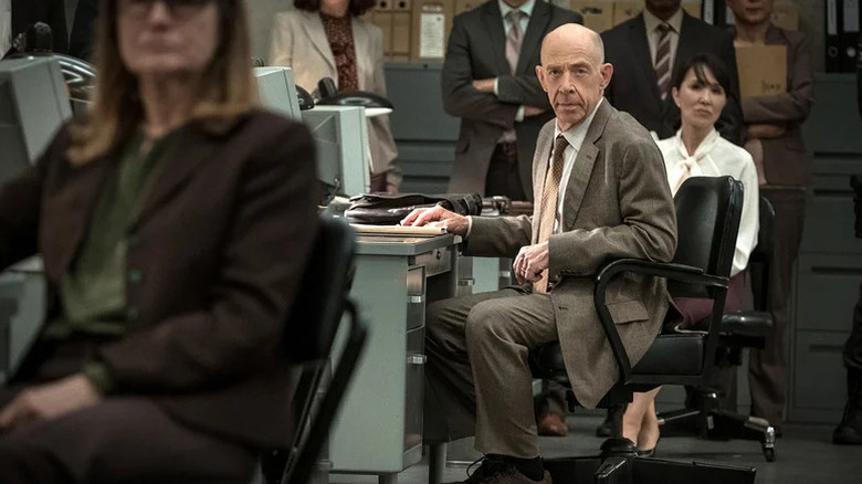 J.K. Simmons as Harold sitting in office surrounded by colleagues in Counterpart