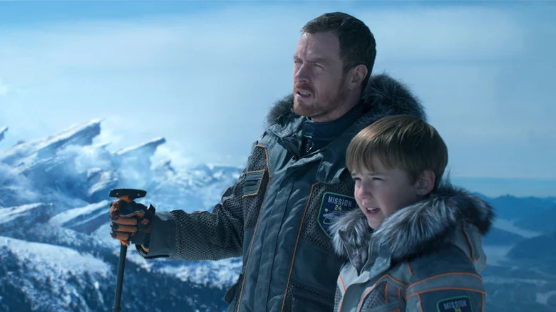 John (Toby Stephens) and Will (Maxwell Jenkins) standing in icy landscape in Lost in Space