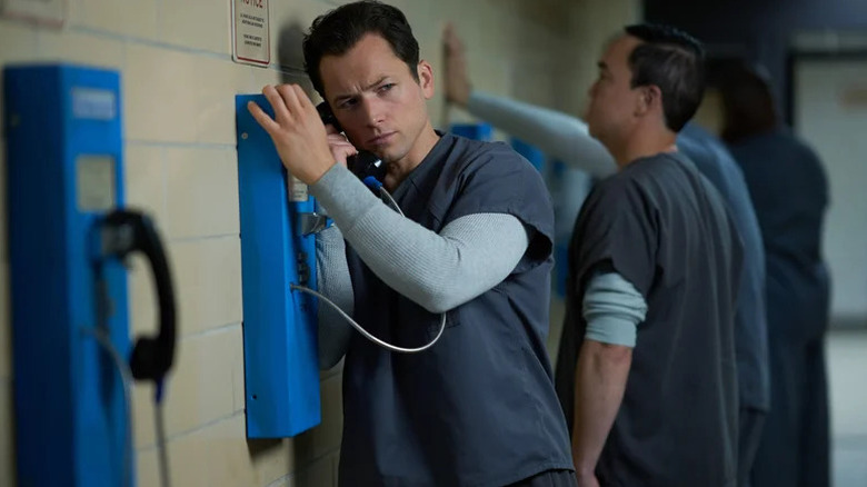 Jimmy Keene talking on telephone in prison