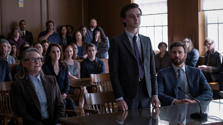 Joanna sitting in courtroom next to Jacob (who is standing) and Andy
