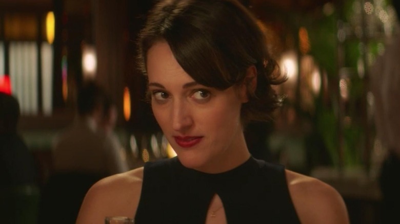 Fleabag at dinner, looking on
