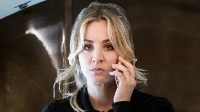 Cassie Bowden holding her cell phone to her left ear in The Flight Attendant